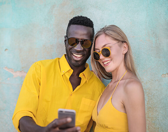 Couple wearing designer sunglasses from Look! Optometry