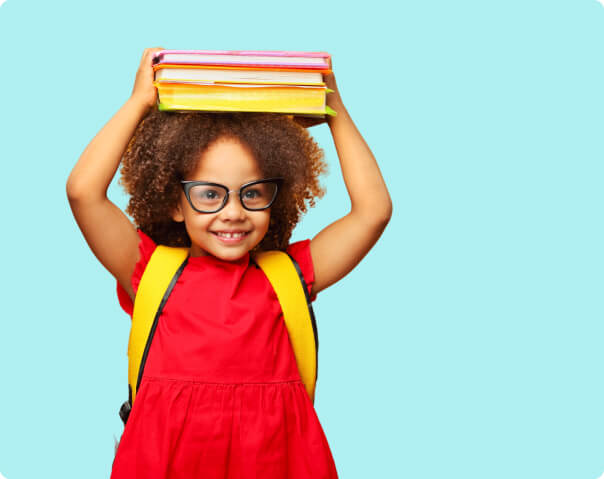 Girl wearing glasses carrying books over her head