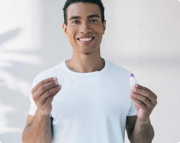 Man holding contacts and contact lens solution