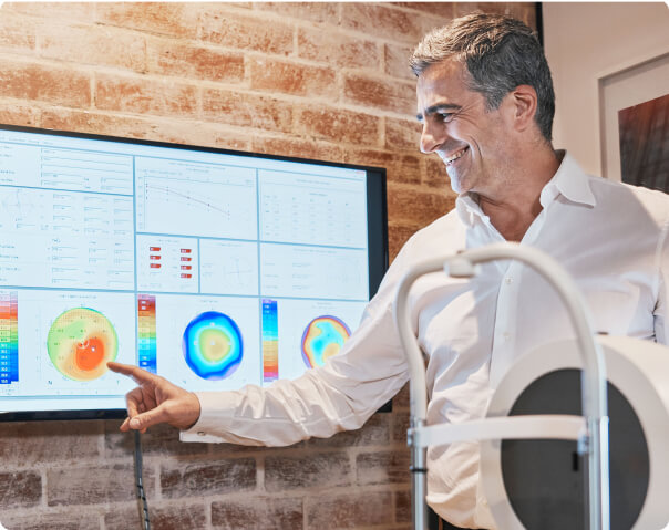 Doctor explaining and pointing at a eye chart